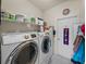 Laundry room featuring a modern, front-load washer and dryer set at 4279 Ashton Club Dr, Lake Wales, FL 33859