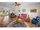The living room has hardwood floors, a ceiling fan, and a view of the front door at 4279 Ashton Club Dr, Lake Wales, FL 33859