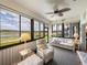 Relaxing sunroom with scenic backyard views, comfortable seating, and carpet flooring at 4279 Ashton Club Dr, Lake Wales, FL 33859