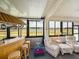 Entertaining sunroom featuring a tiki bar, comfortable seating and a view of the outdoor pond at 4279 Ashton Club Dr, Lake Wales, FL 33859