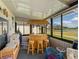 This sunroom features a built-in tiki bar overlooking the scenic backyard pond at 4279 Ashton Club Dr, Lake Wales, FL 33859