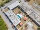 Aerial view of complex with pool, parking, landscaping, and outdoor pavilion at 43420 Highway 27 # 445, Davenport, FL 33837