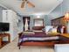 Bedroom showcasing a comfortable bed, dresser, kitchenette, and tile flooring for a functional living space at 43420 Highway 27 # 445, Davenport, FL 33837