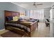 Cozy bedroom with a large bed, ceiling fan, tile flooring, and sheer curtains for natural light at 43420 Highway 27 # 445, Davenport, FL 33837