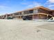 Motel exterior featuring a two-story building, expansive parking lot, and architectural details under a clear blue sky at 43420 Highway 27 # 445, Davenport, FL 33837