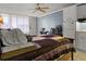 Studio living space featuring a comfortable bed, dining table, kitchenette, and tile flooring at 43420 Highway 27 # 445, Davenport, FL 33837