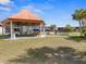Outdoor community space featuring covered seating, pool, lawn, and palm trees at 43420 Highway 27 # 445, Davenport, FL 33837