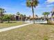 Inviting community pool area with palm trees and seating near the main buildings at 43420 Highway 27 # 445, Davenport, FL 33837