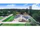 Drone view of the house featuring an attached garage, screened in-ground pool, fenced backyard, and landscaped grounds at 508 Starr Ridge Dr, Lake Wales, FL 33898