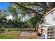 Backyard brick path leads to a fenced lot, complete with a shed and shelves for garden storage at 508 Starr Ridge Dr, Lake Wales, FL 33898