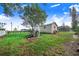 Spacious backyard featuring a water treatment system, shed, and green grass at 508 Starr Ridge Dr, Lake Wales, FL 33898