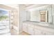 Bathroom with a single sink vanity and shower with tile surround leading to the pool area at 508 Starr Ridge Dr, Lake Wales, FL 33898