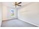 Bright, carpeted bedroom with a ceiling fan and a view to the outdoors through the window at 508 Starr Ridge Dr, Lake Wales, FL 33898