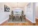 Bright dining room featuring a modern chandelier, neutral walls, and a large window with backyard view at 508 Starr Ridge Dr, Lake Wales, FL 33898