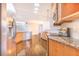 Well-lit kitchen showcasing stainless steel appliances, granite counters and wood cabinets at 508 Starr Ridge Dr, Lake Wales, FL 33898