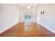 Open living room with hardwood floors, vaulted ceiling, and sliding glass doors to the backyard and pool at 508 Starr Ridge Dr, Lake Wales, FL 33898