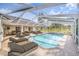 Spacious screened-in pool with open-air design and expansive brick patio, furnished with dining and lounge sets at 508 Starr Ridge Dr, Lake Wales, FL 33898