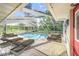 Screened-in pool with an open-air design and brick patio, furnished with lounge chairs at 508 Starr Ridge Dr, Lake Wales, FL 33898