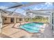Spacious screened-in pool with open-air design and expansive brick patio surrounded by green landscape at 508 Starr Ridge Dr, Lake Wales, FL 33898