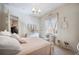 Bright bedroom features a decorative chandelier and lovely furniture at 5200 Pebble Beach Blvd, Winter Haven, FL 33884