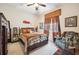 Comfortable bedroom with ceiling fan, decorative art, and warm colors at 5200 Pebble Beach Blvd, Winter Haven, FL 33884