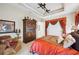 Bedroom showcasing decorative valances and a large wooden armoire at 5200 Pebble Beach Blvd, Winter Haven, FL 33884