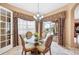 Bright breakfast nook with a glass table and views of the screened-in pool area at 5200 Pebble Beach Blvd, Winter Haven, FL 33884