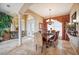 Elegant dining room with travertine floors, decorative columns, and a stylish chandelier at 5200 Pebble Beach Blvd, Winter Haven, FL 33884