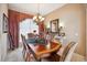 A cozy dining room features a wooden table, elegant chandelier, and decorative accents at 5200 Pebble Beach Blvd, Winter Haven, FL 33884