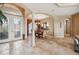 Open concept living and dining room with stone columns and light brown tile flooring throughout at 5200 Pebble Beach Blvd, Winter Haven, FL 33884