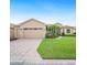 Charming single-story home with a well-manicured lawn, brick driveway, and attached two-car garage at 5200 Pebble Beach Blvd, Winter Haven, FL 33884