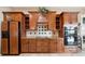 Kitchen with wood cabinets, granite counters, stainless steel appliances and tile backsplash at 5200 Pebble Beach Blvd, Winter Haven, FL 33884