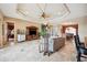 Open living area with tile floors, natural light, and a view to the dining room and kitchen at 5200 Pebble Beach Blvd, Winter Haven, FL 33884