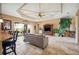 Large living area featuring tile floors, neutral decor, and access to the kitchen and outdoor patio at 5200 Pebble Beach Blvd, Winter Haven, FL 33884