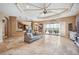 Open concept living room with tile flooring, a ceiling fan, and large sliding glass doors to the patio at 5200 Pebble Beach Blvd, Winter Haven, FL 33884