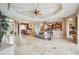 Spacious living room with tile floors, an ornate ceiling, and an open concept design at 5200 Pebble Beach Blvd, Winter Haven, FL 33884