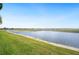 Beautiful water view from the backyard of the property on a sunny day at 5200 Pebble Beach Blvd, Winter Haven, FL 33884