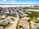 Aerial view of a neighborhood with houses, golf course, and a lake at 530 Eastlake Dr, Haines City, FL 33844