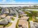 Aerial view of a neighborhood with houses, golf course, lake, and the subject house highlighted in red at 530 Eastlake Dr, Haines City, FL 33844