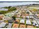 Aerial view of a neighborhood with houses, tennis courts, lake, and trees at 530 Eastlake Dr, Haines City, FL 33844