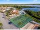 An aerial shot reveals tennis courts, a pool, a clubhouse, and a nearby lake at 530 Eastlake Dr, Haines City, FL 33844