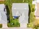 Aerial view of a single Gathering home with a gray roof, and a patio with blue umbrella at 530 Eastlake Dr, Haines City, FL 33844