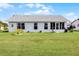 Back exterior of home with well-maintained lawn at 530 Eastlake Dr, Haines City, FL 33844