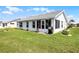 Back exterior of home with well-maintained lawn and partially enclosed lanai at 530 Eastlake Dr, Haines City, FL 33844