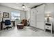 Bright bedroom featuring a Murphy bed, leather chair with ottoman, and tile floors at 530 Eastlake Dr, Haines City, FL 33844