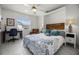 Bright bedroom with a Murphy bed, desk, and decorative chair, showcasing style and functionality at 530 Eastlake Dr, Haines City, FL 33844