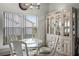 Cozy dining area features a glass table, four chairs, and a cabinet at 530 Eastlake Dr, Haines City, FL 33844