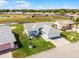 Exterior of light blue single Gathering home featuring a two car garage, paved driveway, and screened patio at 530 Eastlake Dr, Haines City, FL 33844