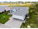 Exterior of light blue single Gathering home featuring a two car garage, paved driveway, and screened patio at 530 Eastlake Dr, Haines City, FL 33844