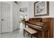Inviting foyer features tile flooring, piano, and entry to other rooms of the house at 530 Eastlake Dr, Haines City, FL 33844